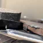 The right rear brake pads with a good one for size comparisson.