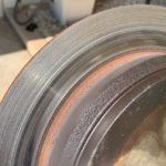 Wear from the brake pads on the right rear rotor.